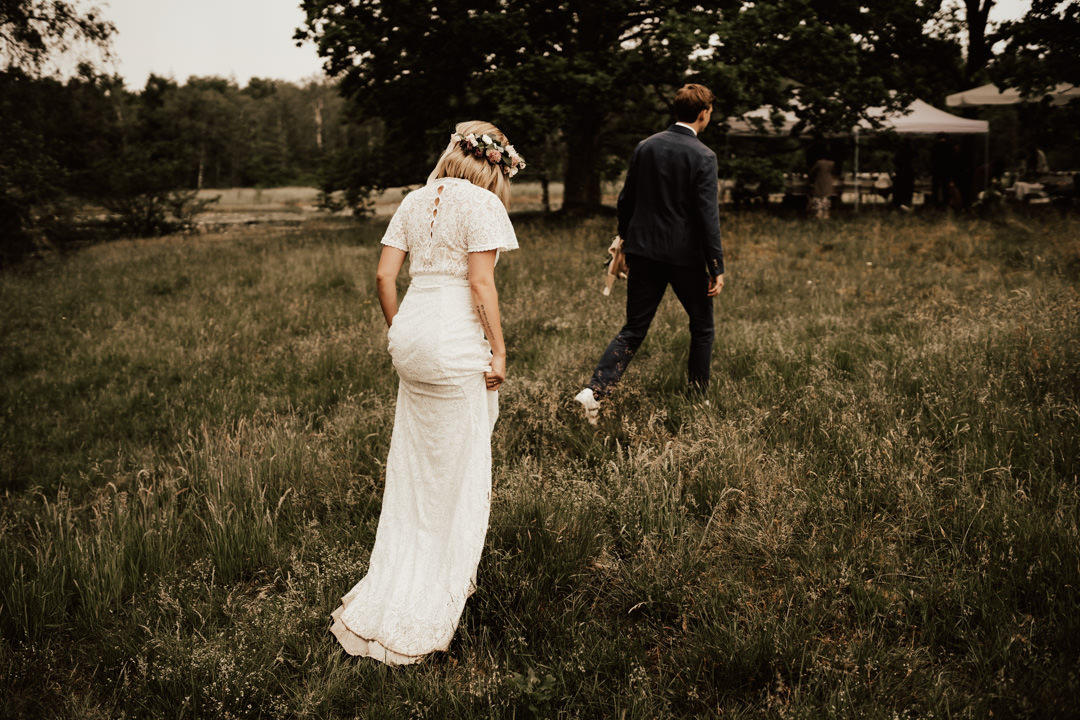 bride and groom walking on swedish midsummer wedding