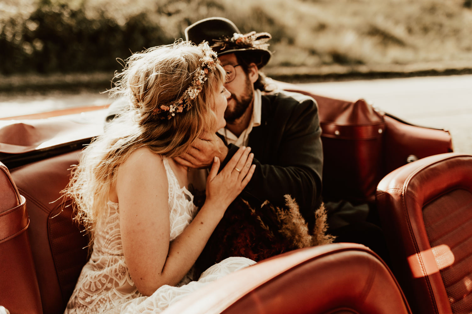 Groom kiss bride in retro car after the ceremony in Borkum Germany