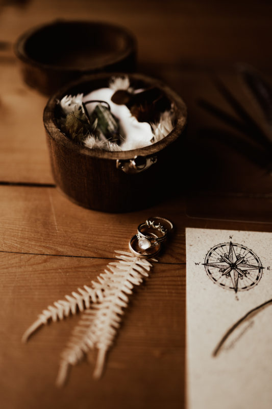 Bohemian wedding rings together with handmade wooden ring box and stationary for the wedding.