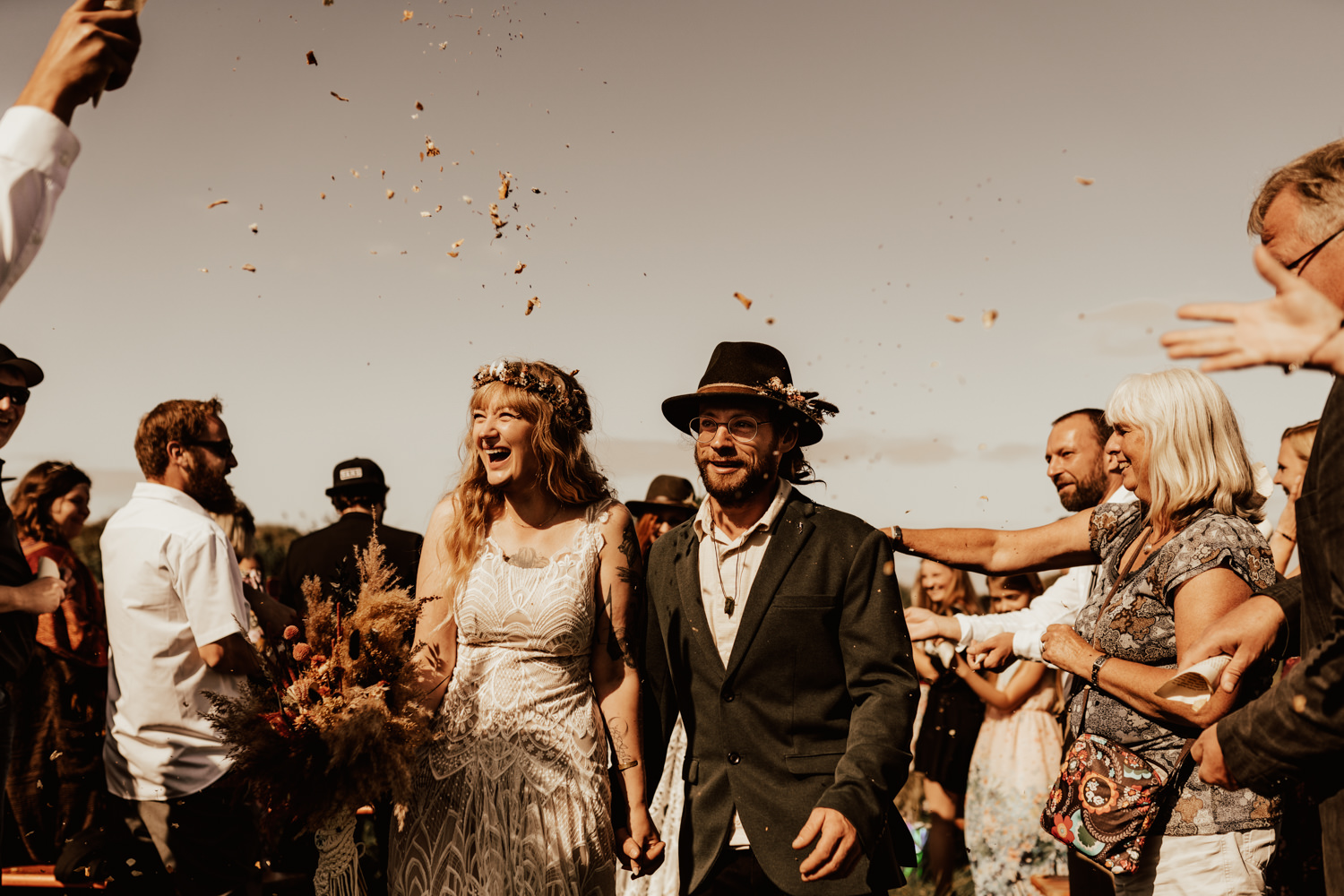 Bohemian wedding couple walking down the aisle during their outdoor festival wedding in Germany